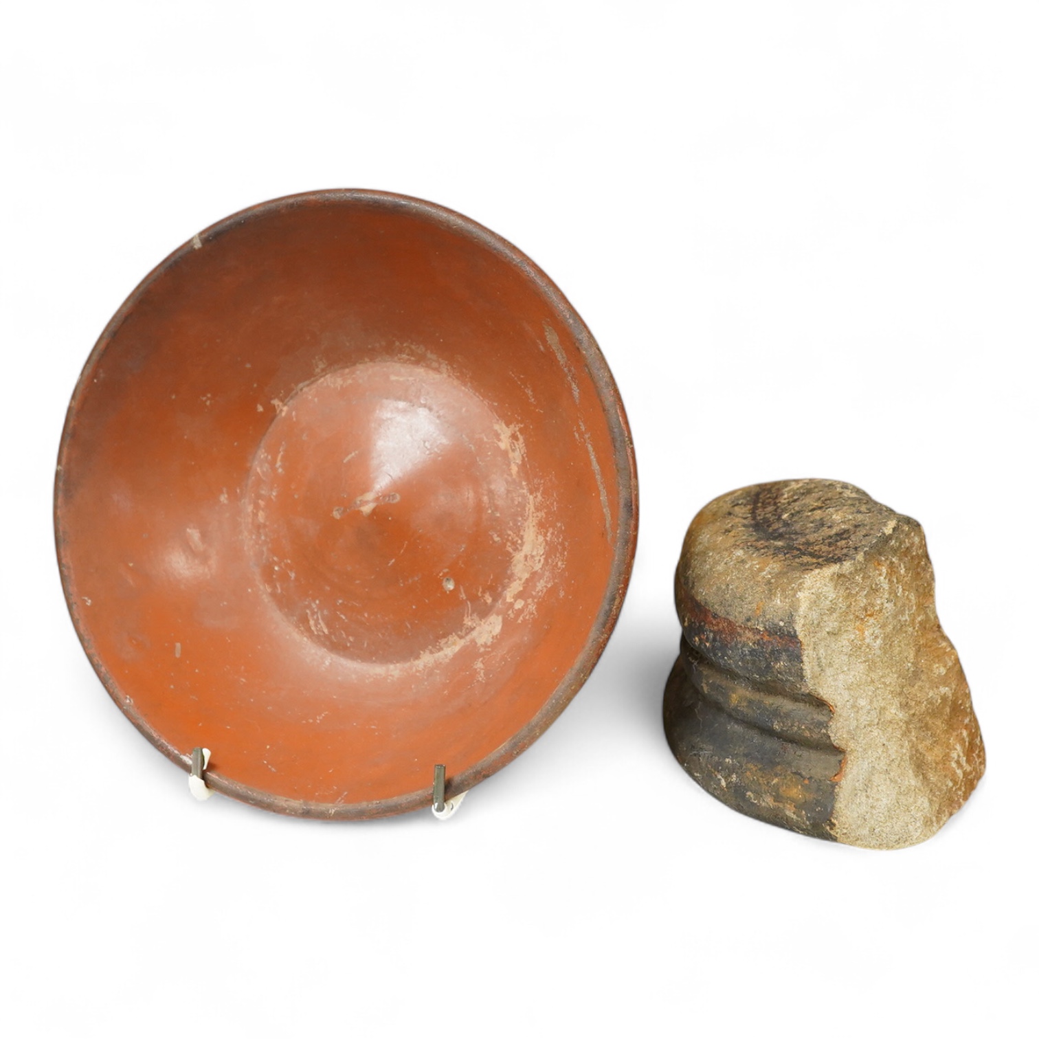 A Roman Samian ware bowl with provenance, allegedly from the Pan Rock shipwreck, together with an Iron Age Quern stone, largest 19cm in diameter